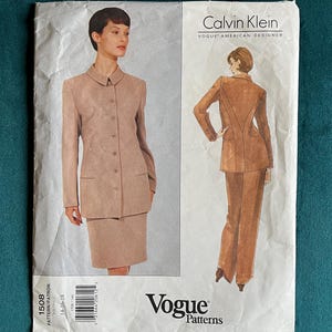 May include: Vogue Patterns sewing pattern featuring a Calvin Klein design. The pattern includes a skirt suit and trousers suit. The image shows a woman wearing the suit. The pattern is labeled 1508.