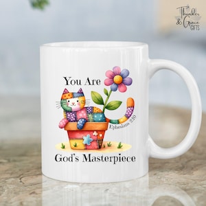 May include: White ceramic mug featuring a colorful patchwork cat in a flower pot with a flower and the text "You Are God's Masterpiece" and "Ephesians 2:10". The mug has a curved handle and is decorated with watercolor illustrations.