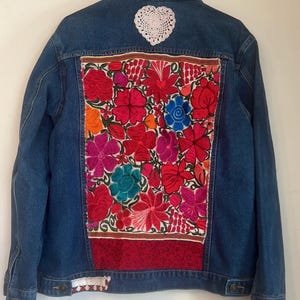 Chaqueta vaquera bohemia con bordados florales vintage reciclados y parches de encaje.
