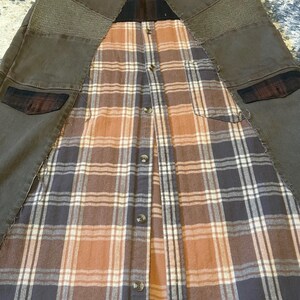 May include: A unique garment featuring a combination of brown denim and a plaid flannel shirt. The denim sections have textured patches and pockets. The flannel has a button-up design with a mix of brown, orange, and white plaid.