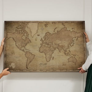 May include: A vintage-style world map printed on canvas with a brown background and faded text. The map shows the continents and oceans of the world. The map is hanging on a white wall.