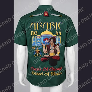 May include: A dark green short-sleeve button-up shirt featuring a back graphic of a person in a turban sitting in a lotus position in front of a building. Text includes ARABIC no 44, Oasis Of Chicago, and Desert Of Illinios with sword icons.
