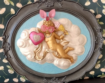 Cheeky pink cherub wall hanging in quirky style with ice-cream, tiara and bunny ears