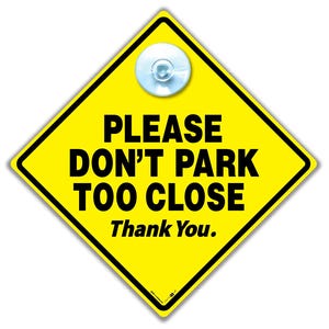 May include: A yellow diamond-shaped sign with black text reading "PLEASE DON'T PARK TOO CLOSE Thank You." A clear suction cup is attached. The sign has a black border, suitable for vehicle use.