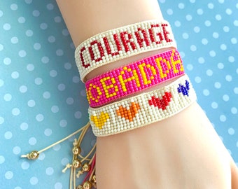Macrame bracelet with brass cat charm and glass rainbow tube and seed beads and square light pink glass beads