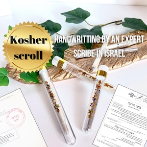 May include: Three clear glass tubes with gold tops containing a white scroll with gold and colored embellishments. The tubes are on a wooden surface with green leaves. A gold seal with the text "Kosher scroll" is in the upper left corner. The text "HANDWRITING BY AN EXPERT SCRIBE IN ISRAEL" is in the upper right corner. A certificate of authenticity is in the lower right corner.