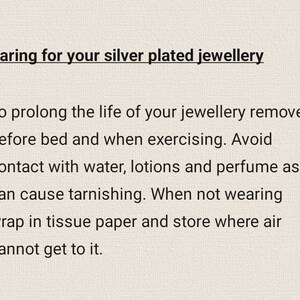 May include: Text on a beige background reads "Caring for your silver plated jewellery." The text provides instructions on how to care for silver-plated jewelry, including removing it before bed and avoiding contact with water, lotions, and perfume.