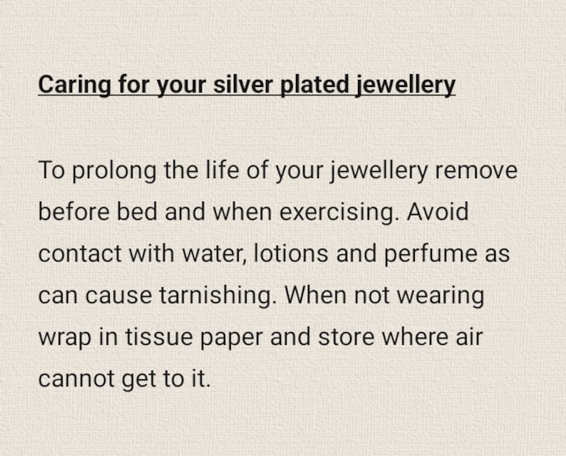 May include: Text on a beige background reads "Caring for your silver plated jewellery." The text provides instructions on how to care for silver-plated jewelry, including removing it before bed and avoiding contact with water, lotions, and perfume.