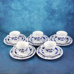 May include: A set of three ceramic mugs with a speckled, matte finish. The mugs are in shades of cream, light gray, and dark gray. Each mug has a simple, minimalist design and a rounded handle.