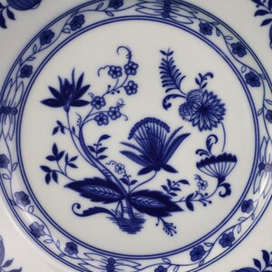 May include: A set of three ceramic nesting bowls in shades of blue, green, and white. The bowls feature a speckled glaze and a simple, modern design. The largest bowl is approximately 7 inches in diameter.