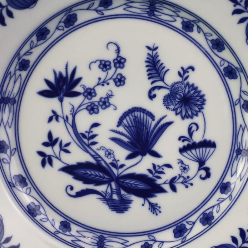 May include: A set of three ceramic nesting bowls in shades of blue, green, and white. The bowls feature a speckled glaze and a simple, modern design. The largest bowl is approximately 7 inches in diameter.