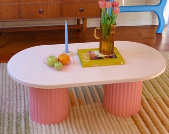 Oval shaped coffee table with chunky fluted legs