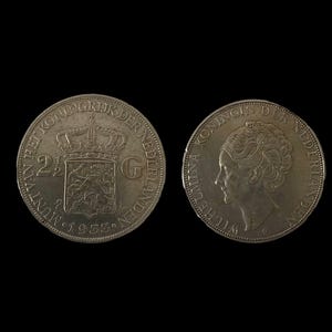May include: Two silver Dutch coins from 1953. The obverse side features the coat of arms of the Netherlands with the inscription "HET KONINKRIJK DER NEDERLANDEN" and "2½ CENT". The reverse side features a portrait of Queen Juliana with the inscription "KONINGIN DER NEDERLANDEN" and "WILLEMINA 1948".