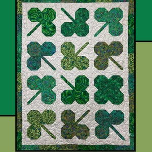 May include: A quilt pattern featuring a clover patch design with green and white fabric. The pattern is called "Clover Patch" and is by Molly Cook for Villa Rosa Designs.