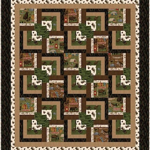 May include: A quilt with a brown, green, and white patchwork design. The quilt features a repeating pattern of squares and rectangles with images of bears, moose, and cabins. The text "Come Explore" and "Cabins" is visible on the quilt.