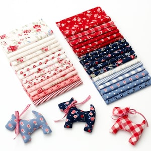 Puede incluir: Dos pilas de muestras de tela rectangulares con patrones florales, de rayas y de cuadros vichy en rojo, azul, rosa y blanco. Tres adornos rellenos con forma de perro hechos de tela a juego con lazos de cinta de cuadros vichy rojos y blancos.