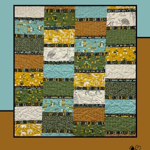 May include: A patchwork quilt with the word "Underline" in yellow letters. The quilt features various patterned squares in shades of green, brown, and blue, with alphabet letters and animal illustrations. The quilt is designed by Molly Cook for Villa Rosa Designs.