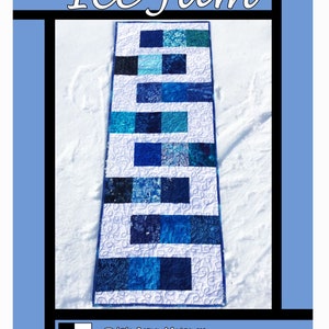 May include: A blue and white quilt pattern called "Ice Jam" designed by Tricia Lynn Maloney for Villa Rosa Designs. The quilt is made of various shades of blue fabric and features a snowflake design.