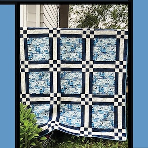 May include: A blue and white quilt with a grid pattern, featuring a repeating design of what appears to be boats. The word "Willow" is at the top. The quilt is designed by Tricia Lynn Maloney for Villa Rosa Designs.