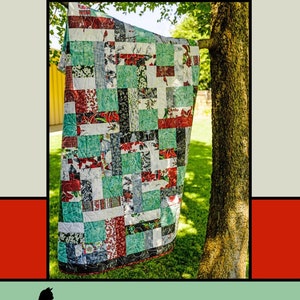 May include: A quilt pattern called "Infinite" by Melissa Milligan for Villa Rosa Designs. The quilt is made of patchwork squares in shades of red, green, white, and black. The quilt is hanging on a tree branch in a grassy area.