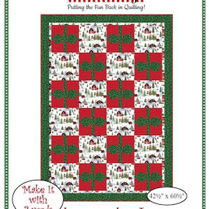 May include: A quilt pattern titled "Pretty Packages" featuring a grid of red gift boxes with green bows on a white background with a winter scene. The quilt measures 42.5 inches by 60.5 inches. The Fabric Cafe logo is at the top.