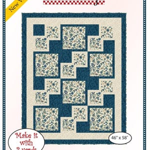 May include: A quilting pattern for a quilt called "Easy Street" by Fabric Cafe. The pattern features a blue and white floral fabric with a navy blue border. The quilt is 46 inches by 58 inches and requires 3 yards of fabric.