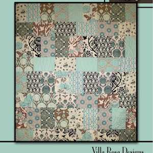 May include: A quilt pattern called "Honey Bouquet" by Villa Rosa Designs. The quilt is made up of a patchwork of squares in various shades of brown, blue, and white. The squares feature floral and geometric patterns. The quilt is surrounded by a border of brown and blue butterflies and flowers.