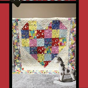 May include: A colorful patchwork quilt with a heart design, featuring squares of various patterns and colors. The quilt has a white background and is framed by a red border. The word "Heartbeat" is written at the top. A rocking horse is in front of the quilt.