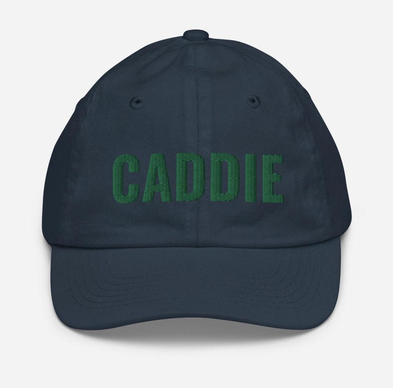 May include: A navy blue baseball cap with the word "CADDIE" embroidered in green.