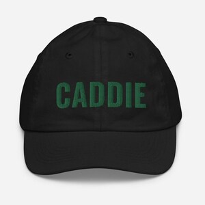 May include: Black baseball cap with the word "CADDIE" embroidered in green.