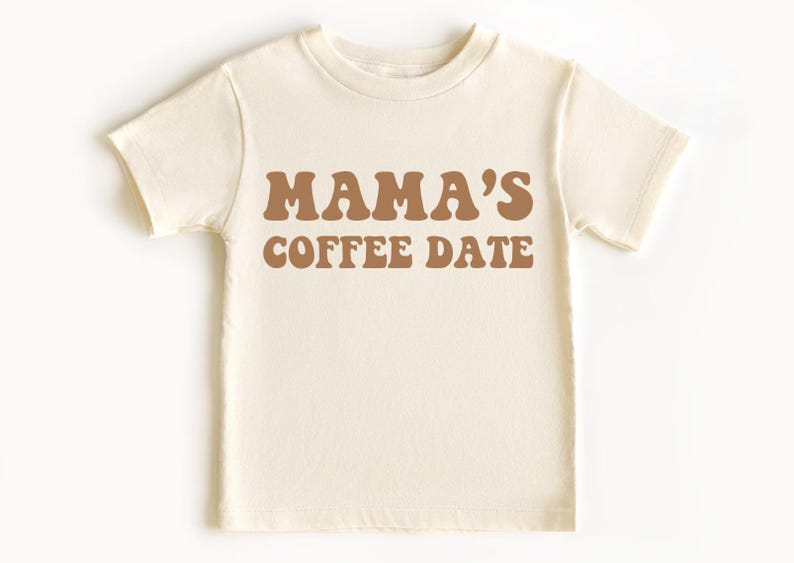 May include: A white short-sleeved t-shirt with the text "MAMA'S COFFEE DATE" in brown letters.