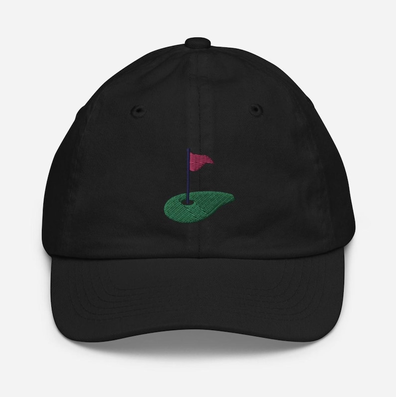 May include: Black baseball cap with an embroidered green golf course and red flag.