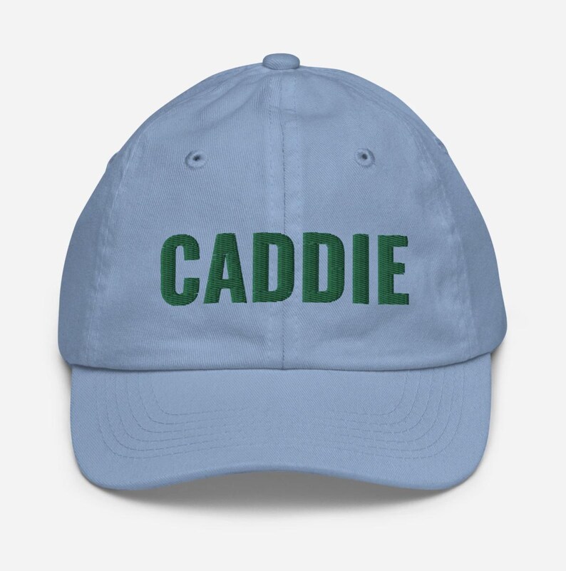 May include: A light blue baseball cap with the word "CADDIE" embroidered in green.