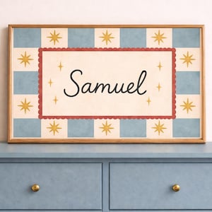 May include: A framed print with the name "Samuel" in a decorative script. The background has a light blue and cream checkered pattern with gold star accents. The frame is a light wood colour.