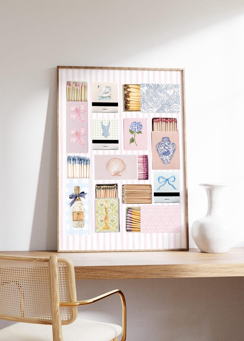 May include: A framed print of a collection of matchboxes with various designs, including a swan, a seashell, a floral pattern, a blue and white vase, and a bottle of champagne. The matchboxes are arranged in a grid pattern on a pink and white striped background.