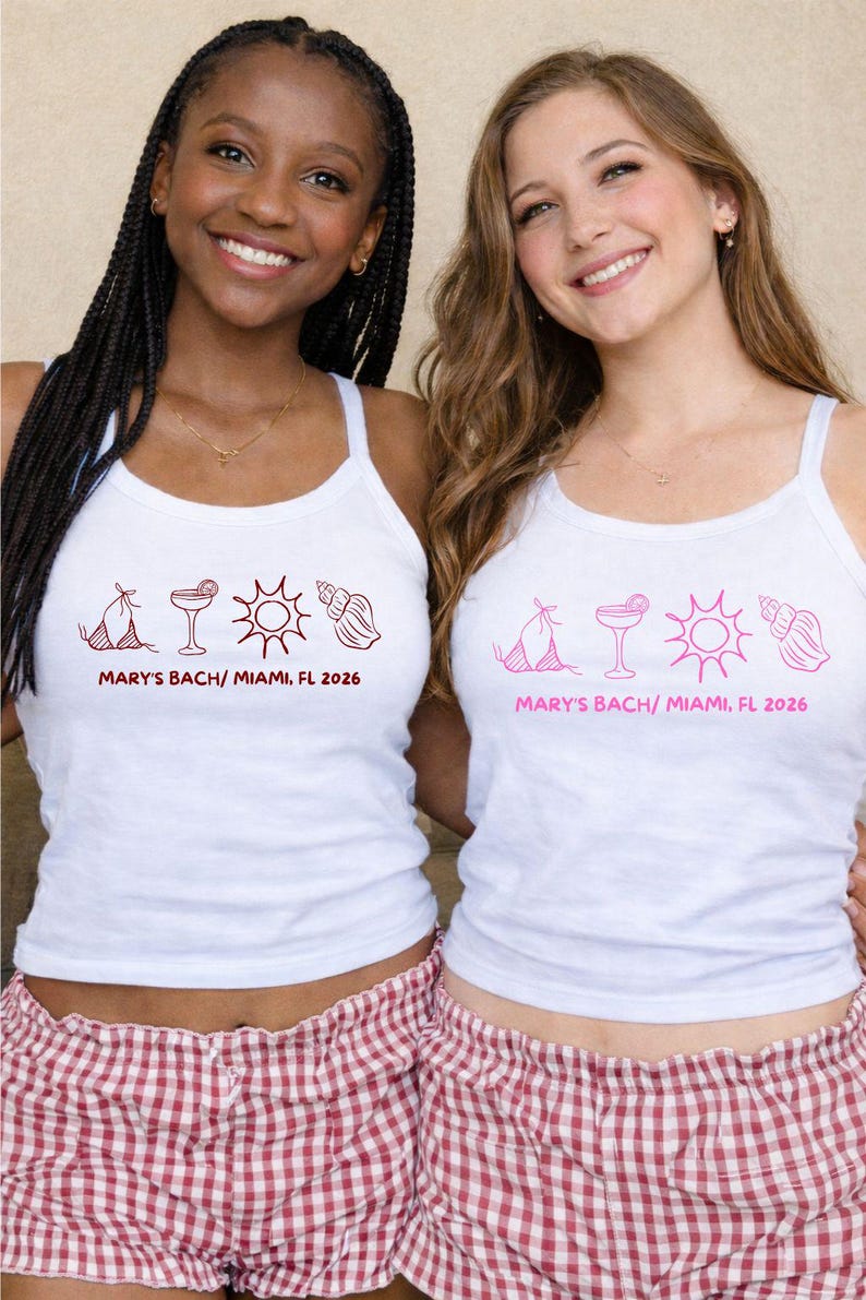 May include: Two women wearing white tank tops with a pink graphic and text that reads "MARY'S BACH/ MIAMI, FL 2026". They are also wearing red and white checkered pajama shorts. The tank tops have a bikini, cocktail, sun, and seashell design.