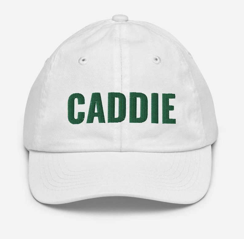 May include: White baseball cap with the word "CADDIE" embroidered in green.
