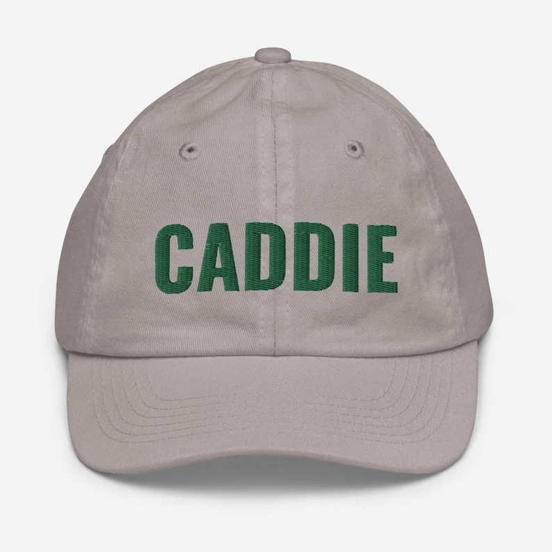May include: A grey baseball cap with the word "CADDIE" embroidered in green.