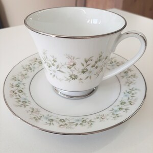 This beautiful vintage (but brand new) porcelain set of 10 cups and 10 saucers made in Japan by Noritake around the 1970s.