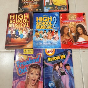 May include: A collection of Disney DVDs and books featuring popular TV shows and movies. Titles include "Wizards of Waverly Place," "High School Musical," "Lizzie McGuire," and "That's So Raven." The covers display colorful graphics and character images.