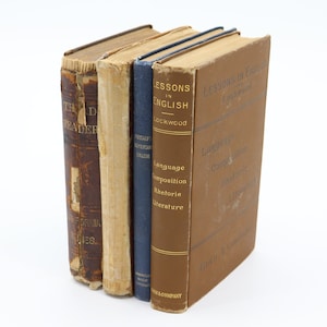 May include: A stack of three vintage brown and blue hardback books with the title "Lessons in English" on the front cover of the top book.
