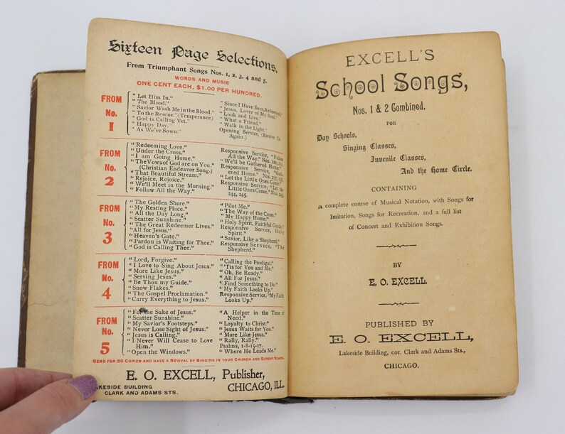 May include: A vintage book titled "Excell's School Songs" with a tan cover and black text. The book contains a collection of songs for day schools, singing classes, juvenile classes, and the home circle. The book is published by E.O. Excell, Lakeside Building, Chicago.