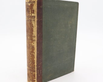 May include: An antique book with a distressed leather spine and a green cover. The spine is tan with embossed decorative elements and shows signs of wear. The cover is a muted green color, and the book appears to be old.