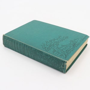 May include: A hardcover book with a teal cover featuring an embossed tree and figure design. The book's spine displays the title "Adventures of David Grayson." The pages have a yellowed appearance, suggesting age. The book is set against a white background.