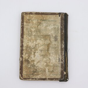 May include: A vintage book with a brown cover and a faded, worn title page. The title page reads "Ewell's Publications." The book is in a worn condition, with visible signs of age and use.