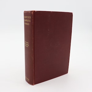 May include: A burgundy hardback book with gold lettering on the spine that reads "Chaucer's Complete Works" and "Oxford's Standard Edition".