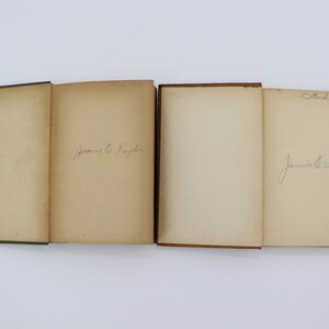 May include: Four vintage books with brown and green covers. The books are open and show blank pages with handwritten signatures. The signatures read "Jennie E. Taylor" and "Mar 6th 1928".