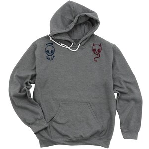 May include: A heather grey hooded sweatshirt with a skull with angel wings on the left side and a skull with horns on the right side.