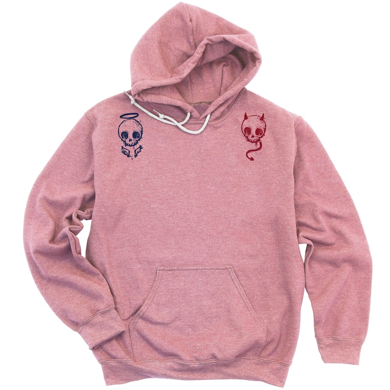 May include: A pink heather hoodie with a skull with angel wings on the left side and a skull with horns on the right side.