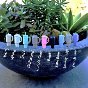 May include: Ten different color tumblers with lids and straws. The colors are ivory, white, surf, driftwood, bubble gum, black, slate blue, smokey beige, and french linen.